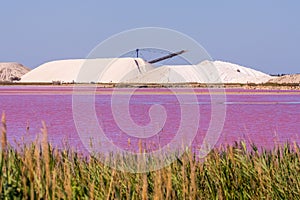 Salt production, pink lagoon and hills in the Mediterranean sea is located in Aigues-Mortes . Camargue, France. Hight