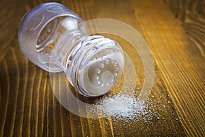Salt shaker and heap of salt