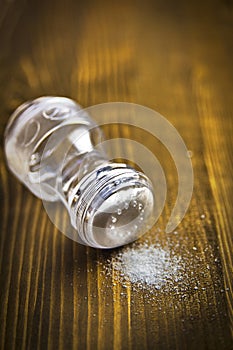 Salt shaker and heap of salt
