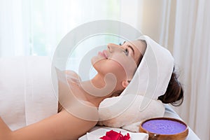 Salt spa massage relaxation concept. Beautiful woman lying down on the bed relax in spa salon with massage