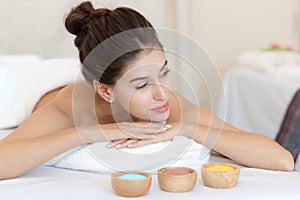 Salt spa massage relaxation concept. Beautiful woman lying down on the bed relax in spa salon with massage