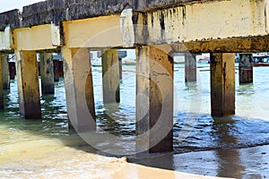 Salt Water Corrosion - Wear and Tear - Erosion and Damage in an Old Worn out Concrete Bridge over Sea Water