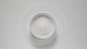 Salt in white dish on a table, Top view