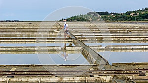 Salt workers  salt minerin salt pan  saltworks `soline` in SeÄovlje - Sicciole  Portoroz  Obalno-kraska  Slovenia  June 2020.