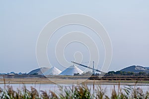Salt works, industrial plant with white piles of Camagrue sea sa
