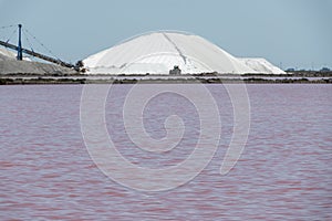 Salt works, industrial plant with white piles of Camagrue sea salt and pink salty lakes, Aigues-Mortes, Gard, Occitania region of