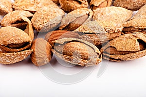 salted almonds in shell close up on white background