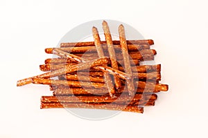 Salted Baked brown Pretzel Sticks on white background,copy space,top view