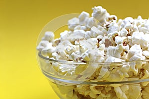 Salted crispy popcorn lies on a glass plate