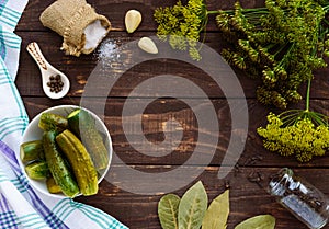 Salted cucumbers. Spices and herbs for making pickles.