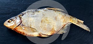 Salted Dry fish vobla on blue stone background