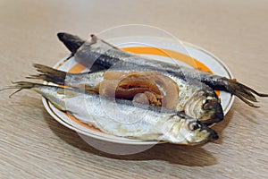 Salted fish Clupea harengus membrane with caviar lies on a plate. Close-up, selective focus