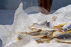 Salted fish lies in unfolded paper