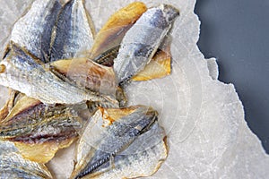 Salted fish lies in unfolded paper