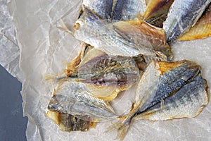 Salted fish lies in unfolded paper