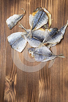 Salted fish lying on a wooden table