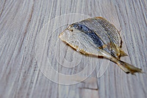 Salted fish lying on a wooden table