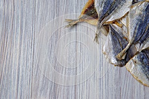 Salted fish lying on a wooden table