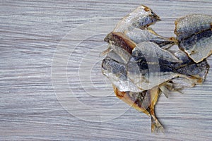 Salted fish lying on a wooden table