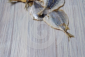 Salted fish lying on a wooden table