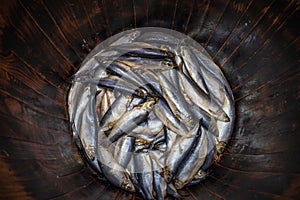 Salted fresh herring fish in wooden oak barrel, traditional seafood