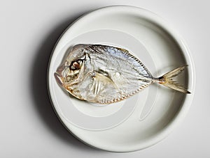 Salted moonfish on white plate