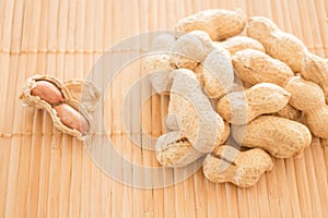 Salted peanuts on kitchen bamboo mat