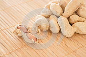 Salted peanuts on kitchen bamboo mat