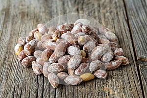 Salted peanuts on wood floor. bulk peanut kernels