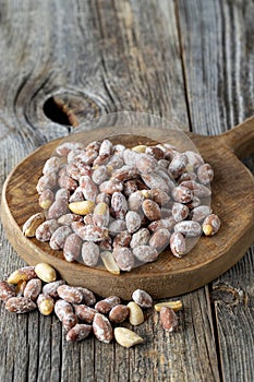 Salted peanuts on wood floor. bulk peanut kernels