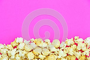 Salted popcorn mix with cheese popcorn frame on pink paper background, have copyspace