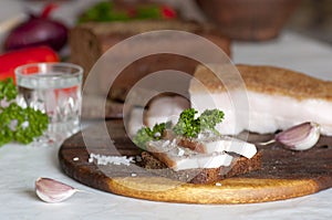 Salted pork lard (salo) on rye bread and vodka photo