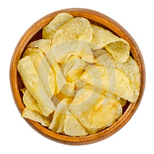 Salted potato chips with peel, also crisps, in wooden bowl