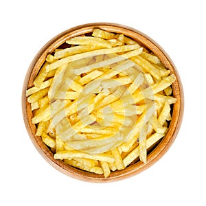 Salted potato sticks, shoestring potatoes, in a wooden bowl