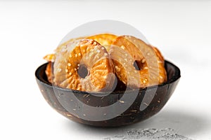Salted Pretzel thins in black bowl on white table