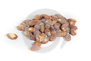 Salted and roasted almonds isolated on white