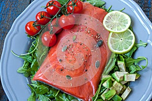 Salted salmon with herbs, tomatoes and salad