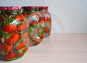 Salted tomatoes in a glass jar. Home preservation.