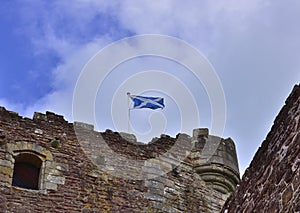 Saltire Flying over Historic Medieval Castle of Central Scotland