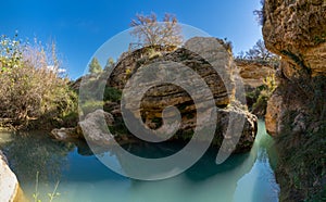 The Salto del Usero nature reserve with eroded sandstone cliffs and colorful pools of water