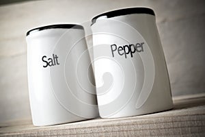 Saltshaker and pepper pot closeup photo