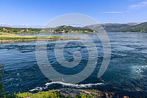 The Saltstraumen current is a symphony of color and motion, its vibrant blues and whites creating a stunning natural mosaic