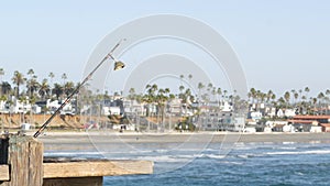 Saltwater angling on pier, fishing tackle or gear. California USA. Sea ocean water, rod or spinning.