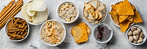 Salty beer snacks in whit bowls