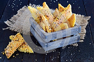 Salty biscuits with sesame seeds in a wooden box