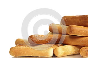 Salty bread sticks on white background
