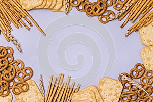 Salty Crackers Sticks Pretzels Top View Above Blue Background Party Snacks Mix Variety of Tasty Crackers for Beer Flat Lay