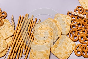 Salty Crackers Sticks Pretzels Top View Above Blue Background Party Snacks Mix Variety of Tasty Crackers for Beer Flat Lay