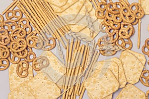 Salty Crackers Sticks Pretzels Top View Above Blue Background Party Snacks Mix Variety of Tasty Crackers for Beer Flat Lay Toned