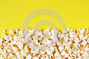 Salty popcorn on yellow background